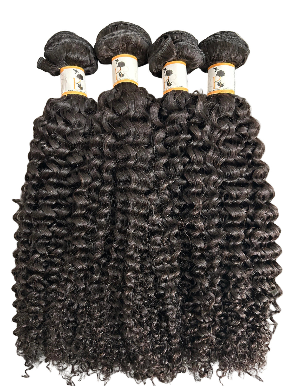 Four bundles of dark brown to near-black curly hair extensions laid flat on a gray textured fabric background. Each bundle is secured with a white paper band featuring a black hair silhouette graphic.